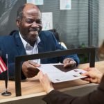 A first-time immigrant homebuyer reviews mortgage documents and alternative credit requirements for ITIN financing.